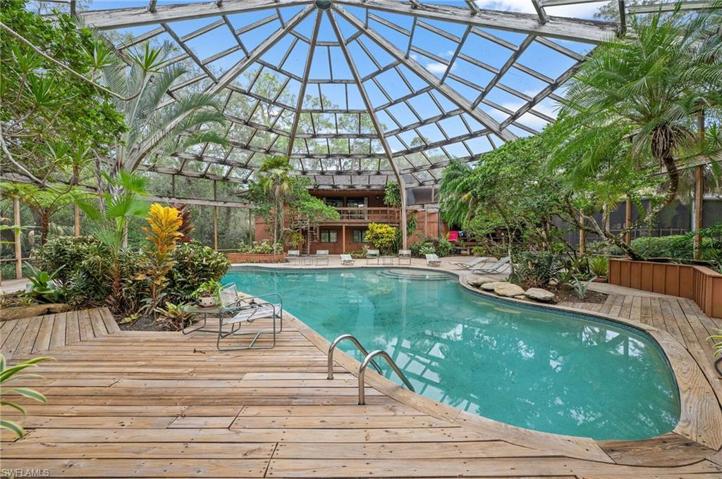 Pool with massive wood & screen enclosure