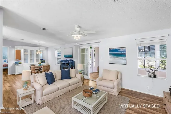 Living room featuring wood finished floors and a ceiling fan