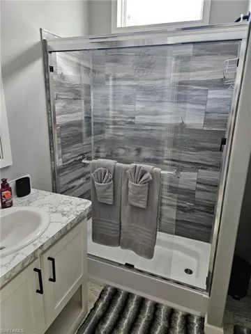 Full bathroom with a stall shower and vanity