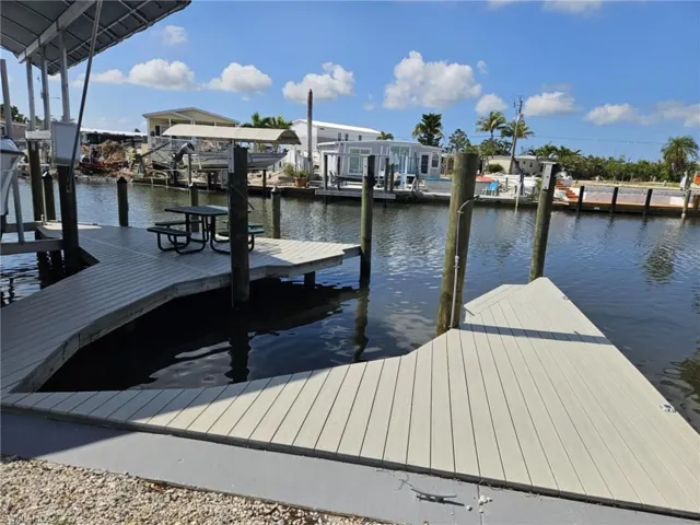 Dock area with boat lift and a water view
