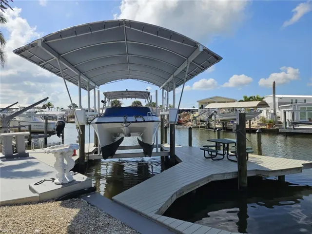 Dock area featuring boat lift and a water view
