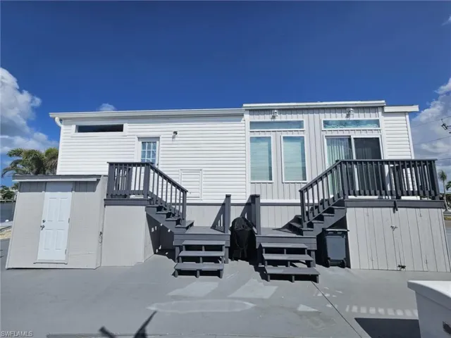 Rear view of property with a patio area and stairway
