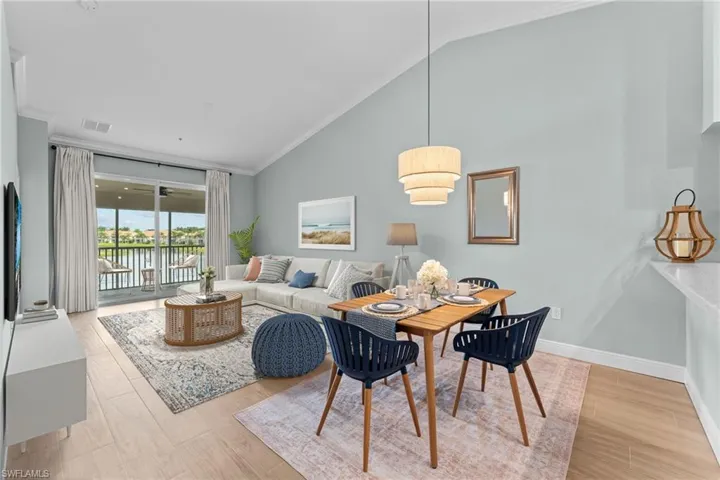 Partially Virtually Staged. Combo living / dining area with gorgeous water view. West facing - beautiful sunsets.