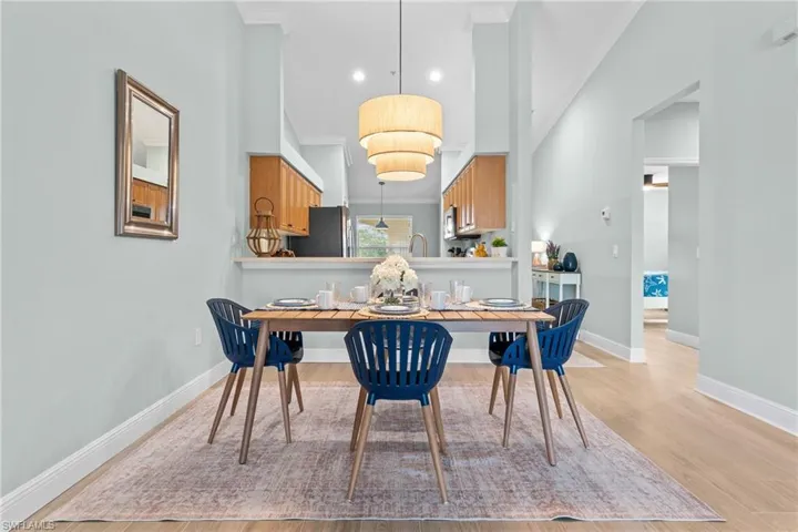 Dining / Living area - Open floor plan. SW sea salt paint throughout, tile plank floors throughout, beautiful cathedral ceilings. Opening is to guest bedroom, guest bath, laundry room.