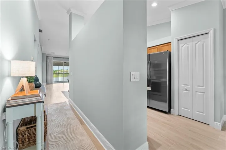 Hallway to main living area. Open to the right for kitchen and breakfast nook, view of pantry doors.