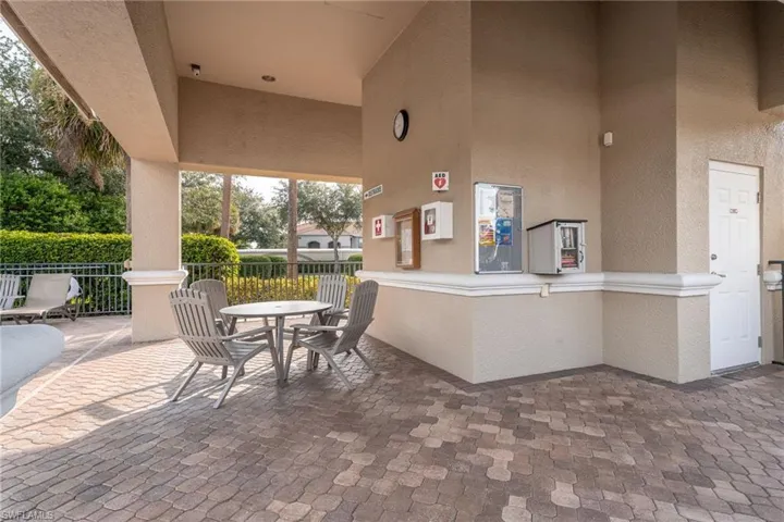 Covered sitting space with bathrooms at the satellite pool.
