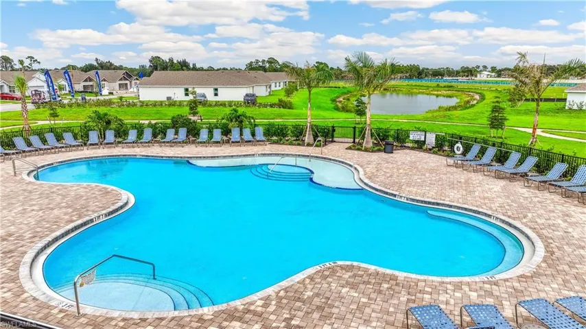 Community pool featuring a patio, a water view, and a residential view