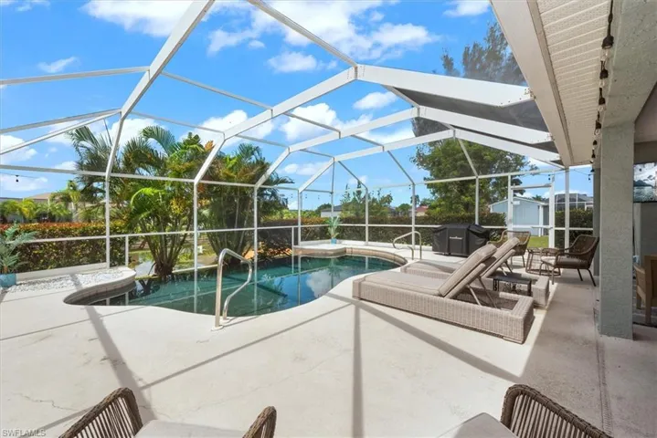 Outdoor pool with a patio area and a lanai