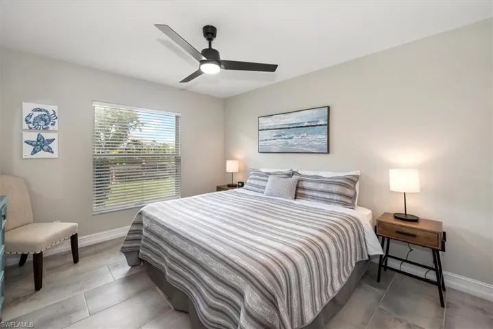 Tiled bedroom with baseboards and a ceiling fan