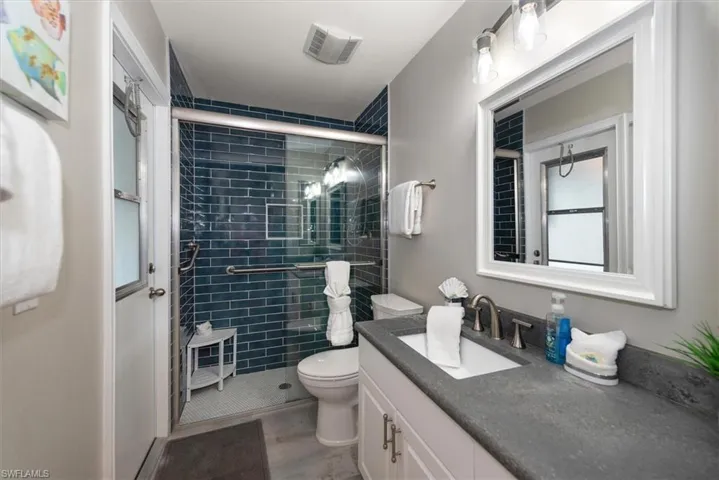 Bathroom featuring vanity and a stall shower