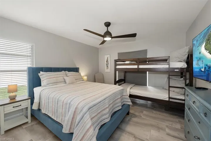 Bedroom featuring a ceiling fan and light wood-type flooring