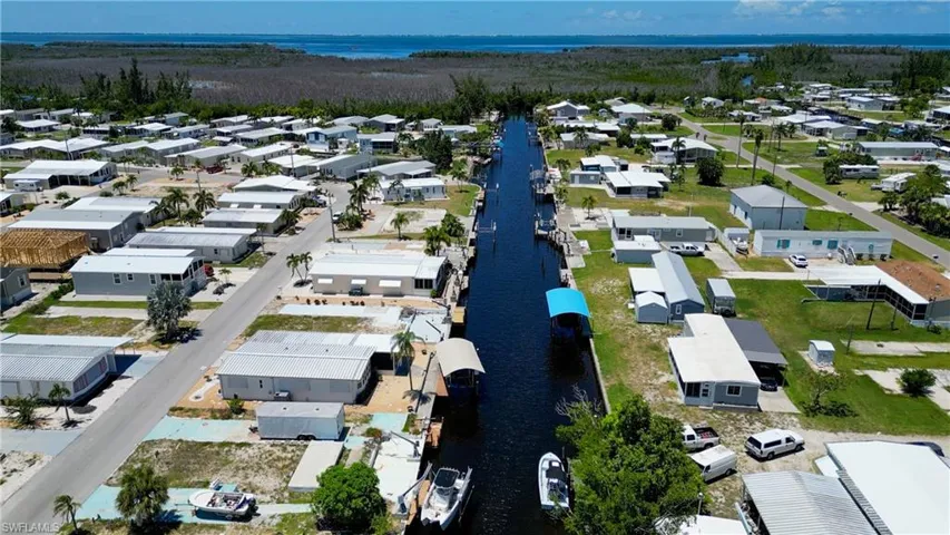 Aerial view of residential area featuring a nearby body of water