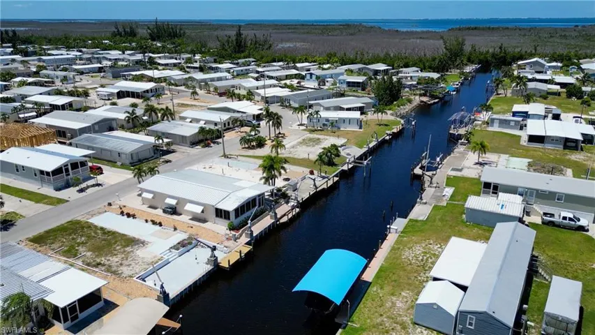 Dock area featuring a water view, a yard, and a residential view