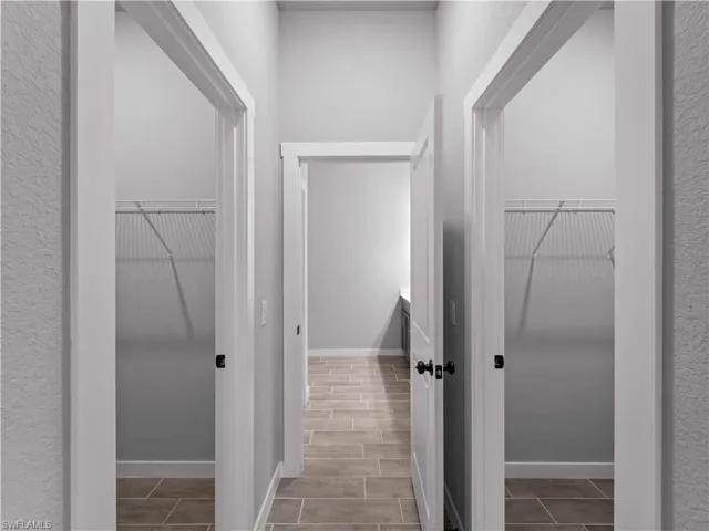 Hallway with baseboards and wood tiled floors