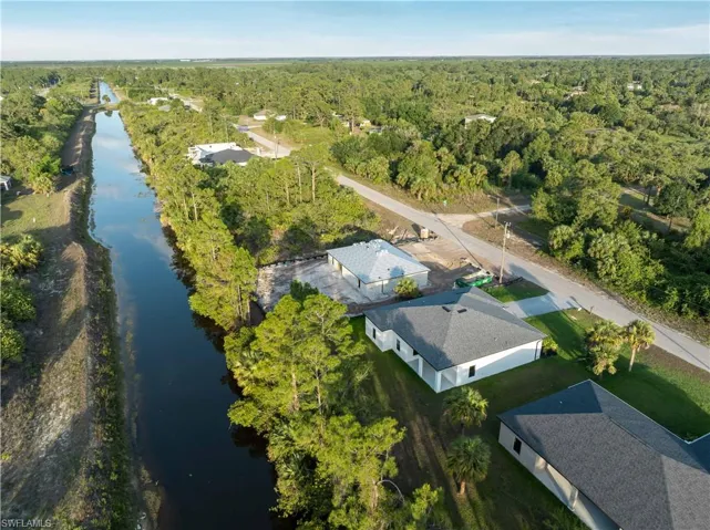View of property location featuring a forest and a large body of water