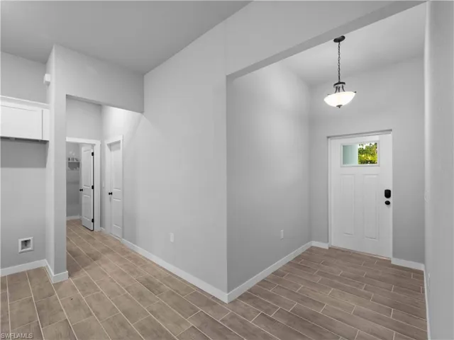 Entryway featuring wood finished floors and baseboards