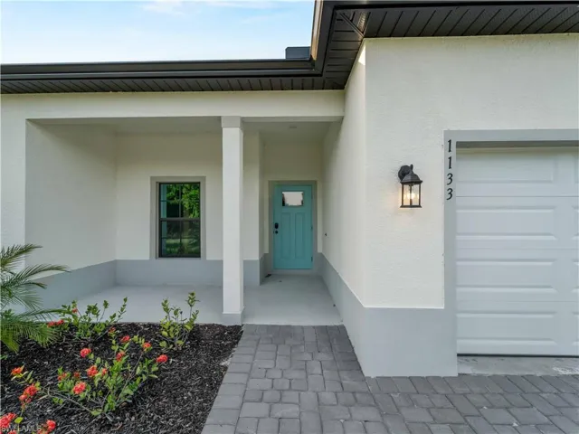 Entrance to property with stucco siding