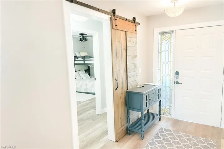 Mudroom with a barn door and light wood-type flooring