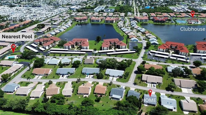 Aerial view of property's location with a large body of water and nearby suburban area