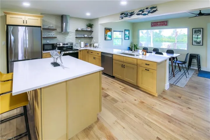 The modern kitchen seamlessly flows into the dining area, creating an open and inviting space perfect for entertaining.