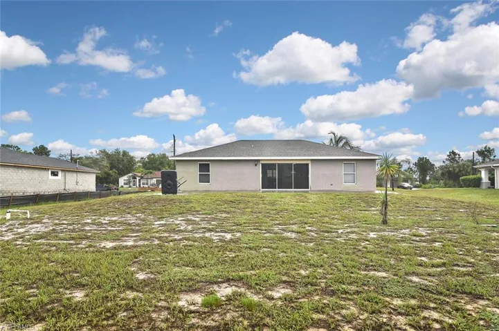 Back of property featuring a yard