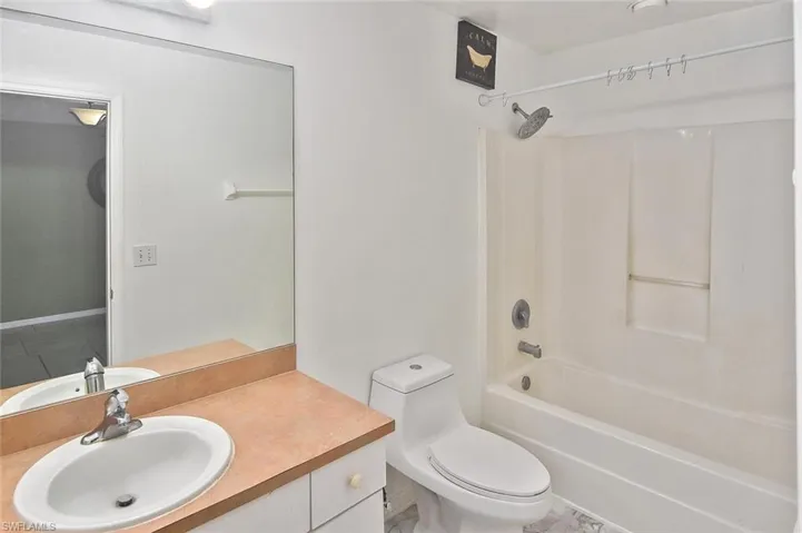 Full bathroom featuring tile flooring, vanity, toilet, and tub / shower combination