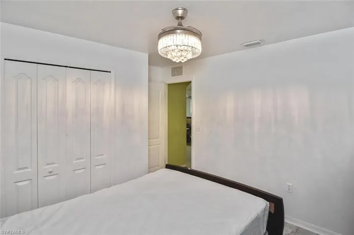 Bedroom featuring a closet and an inviting chandelier
