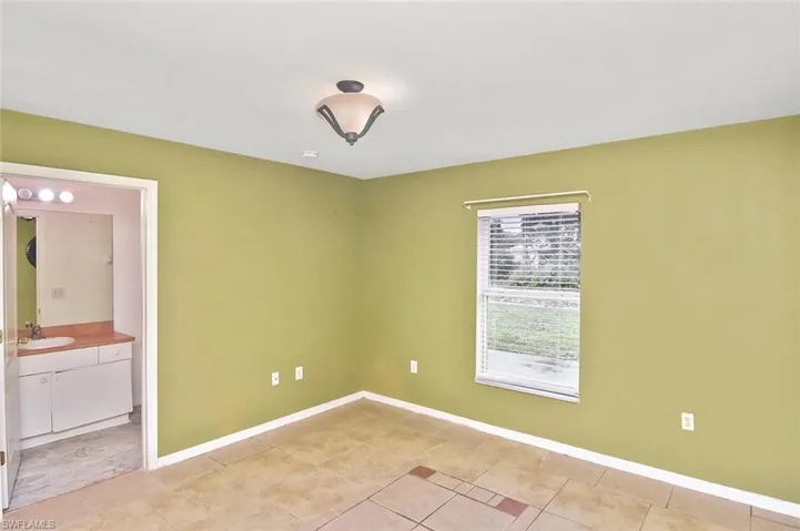 Tiled empty room with sink