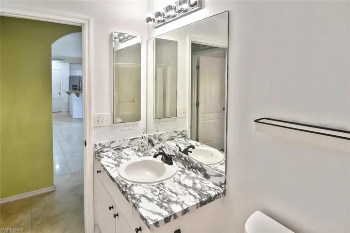 Bathroom featuring tile flooring and vanity
