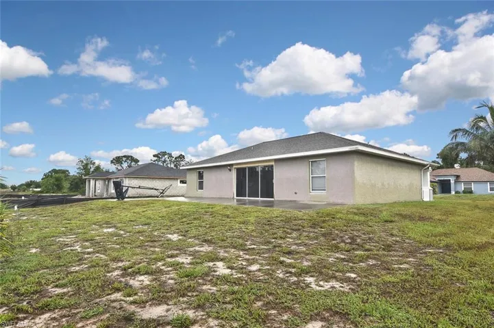 Back of property featuring a patio area and a yard