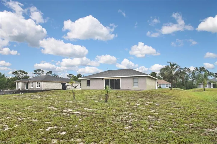 Back of property featuring a yard