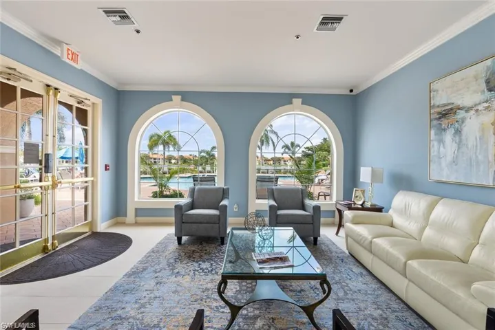 Living room with ornamental molding and tile patterned floors