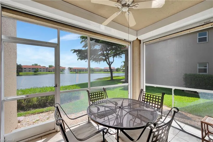 Sunroom / solarium featuring a water view and ceiling fan
