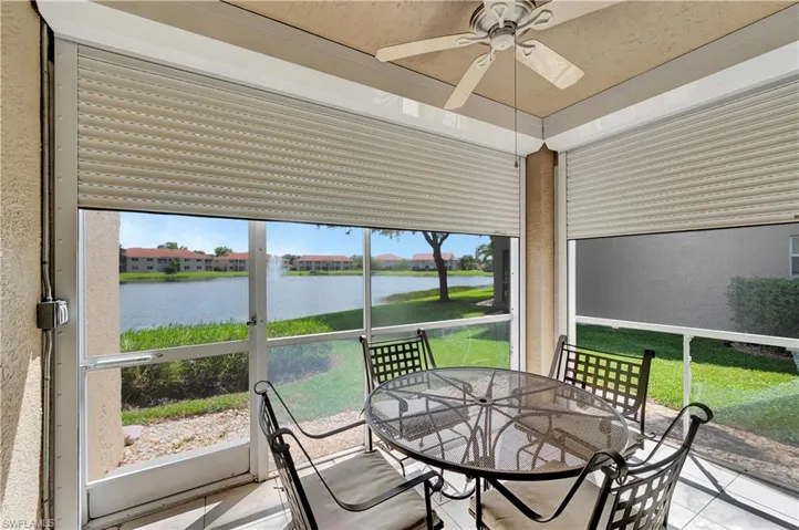 Sunroom with a water view and ceiling fan