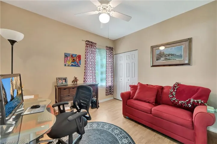 Office with ceiling fan and light hardwood / wood-style flooring