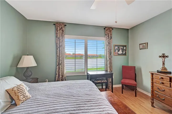 Bedroom with ceiling fan and light wood-type flooring