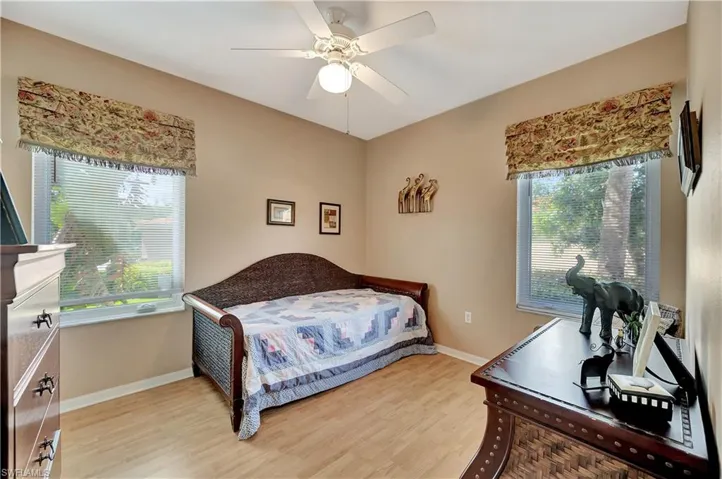 Bedroom featuring ceiling fan and hardwood / wood-style floors