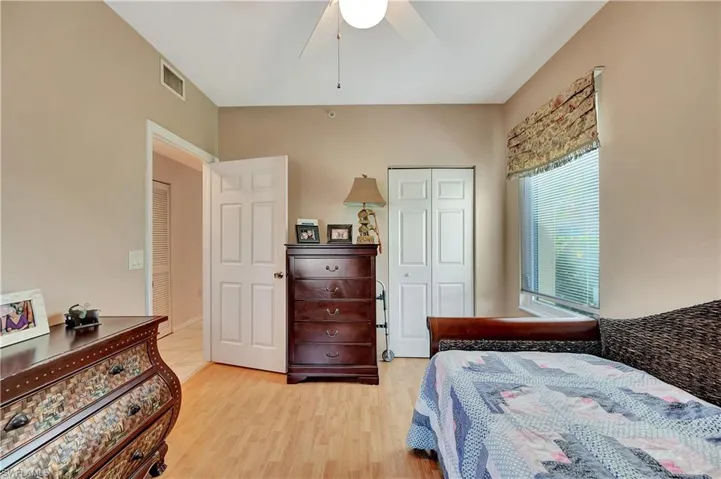 Bedroom featuring light wood-type flooring, ceiling fan, and a closet