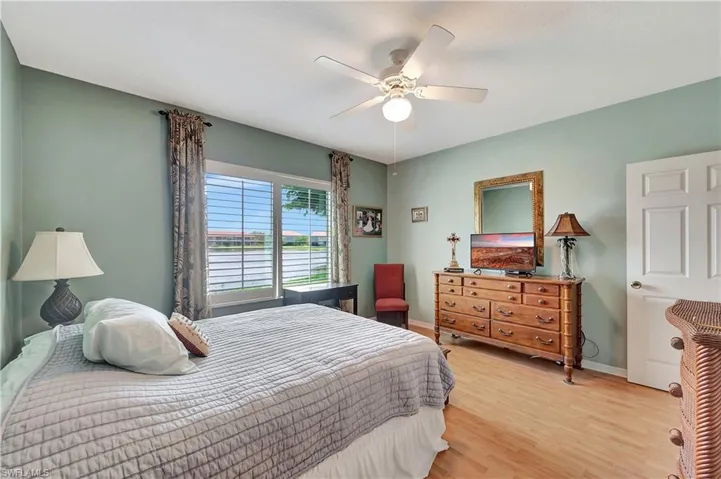 Bedroom featuring ceiling fan and light hardwood / wood-style flooring