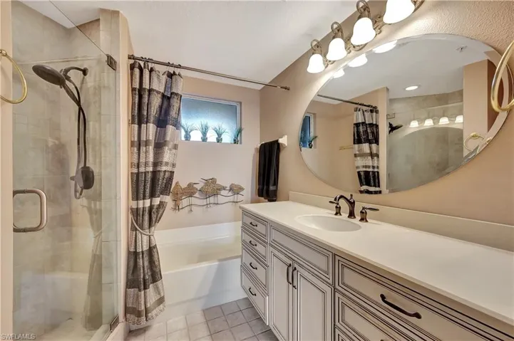 Bathroom with vanity and separate shower and tub