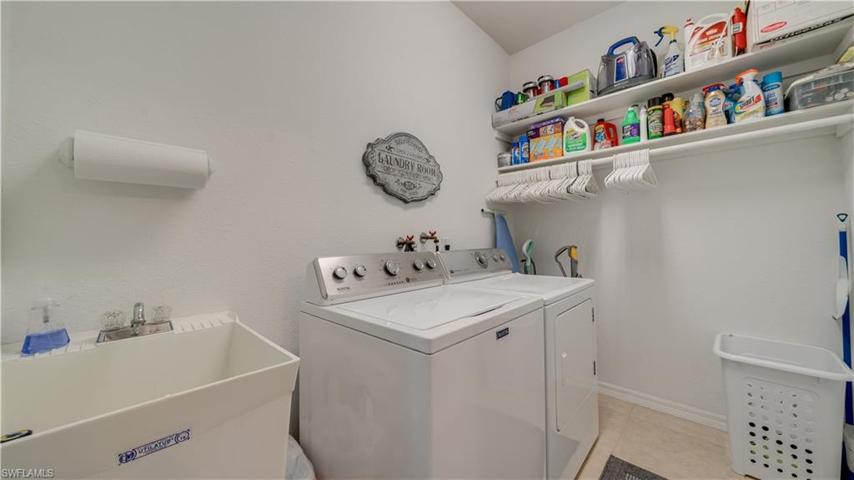 A laundry tub, shelving, and room to spare.