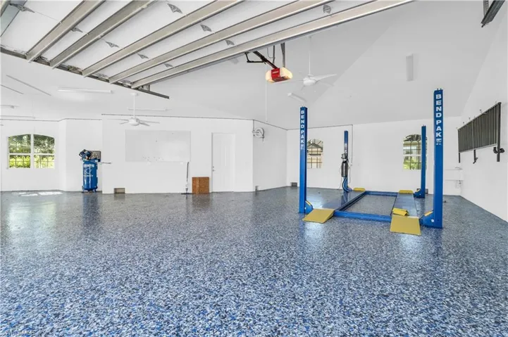 Garage featuring a garage door opener and ceiling fan