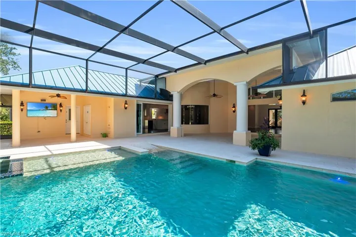 View of pool featuring ceiling fan and a lanai