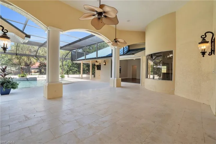 View of patio / terrace featuring a lanai and ceiling fan