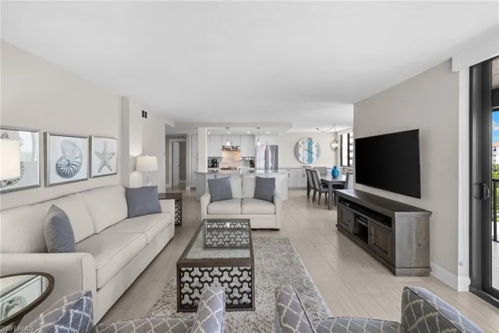 Open-concept living space featuring light wood-finish flooring, recessed lighting, and a neutral color palette