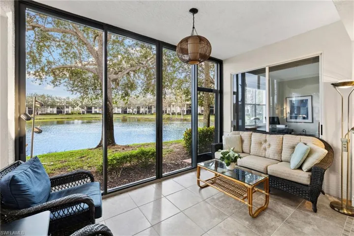 Sunroom featuring a water view