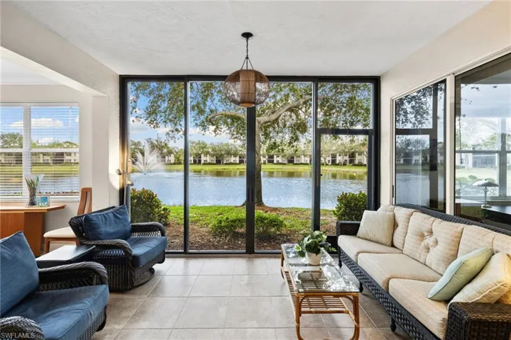 Sunroom / solarium featuring a healthy amount of sunlight and a water view