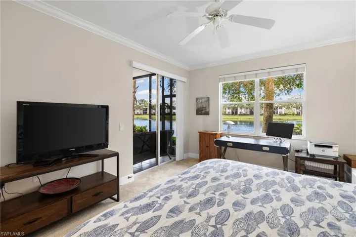 Bedroom with access to exterior, carpet floors, crown molding, baseboards, and ceiling fan