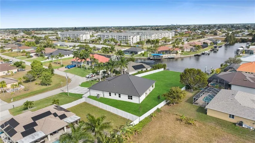 Aerial view of residential area featuring a nearby body of water