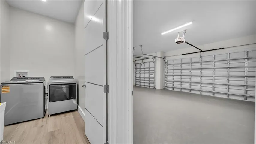 Laundry area with a garage and independent washer and dryer